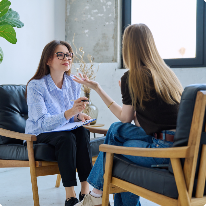 Two women discussing in modern office