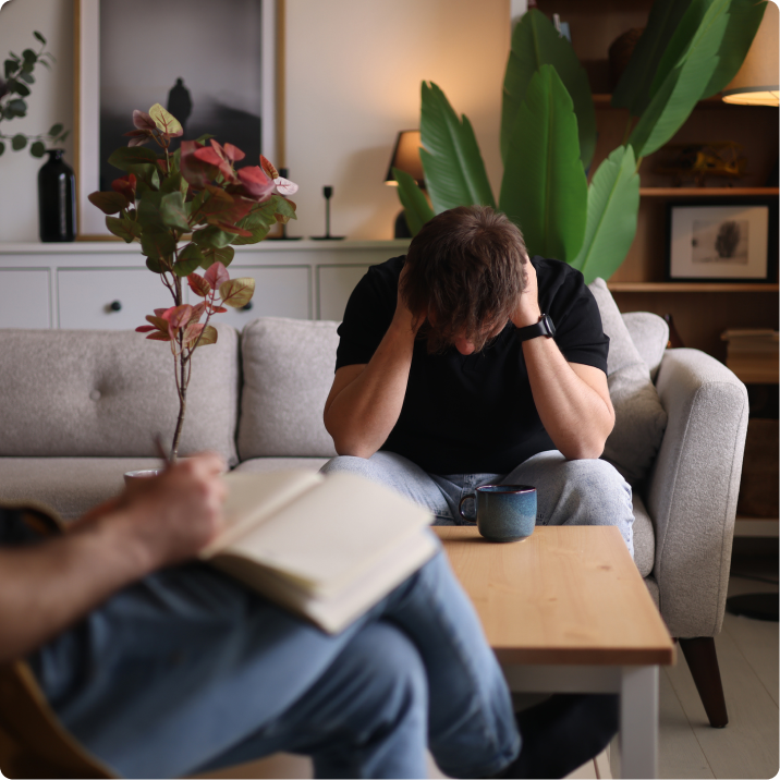Person overwhelmed in living room