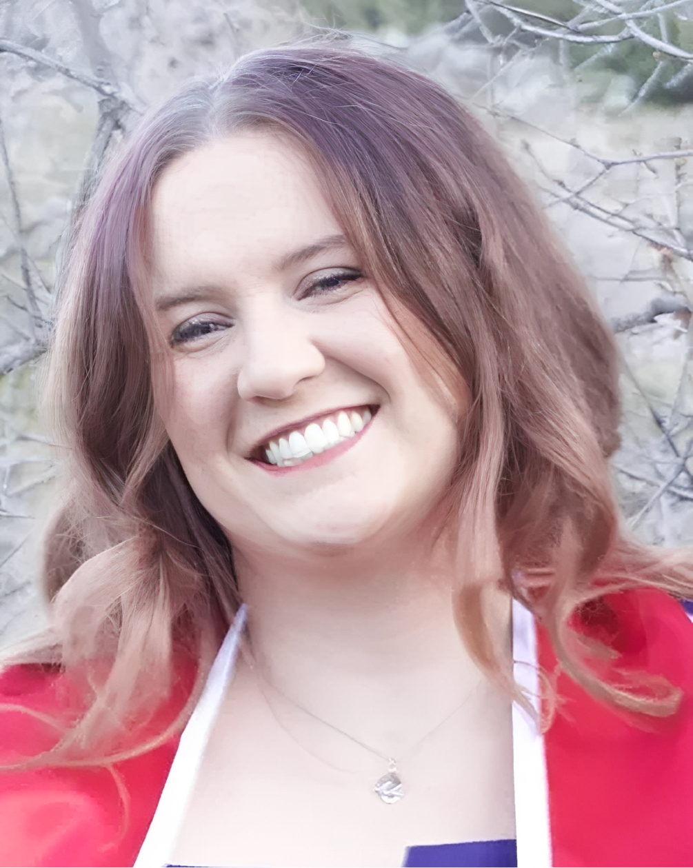 Smiling woman outdoors wearing red jacket